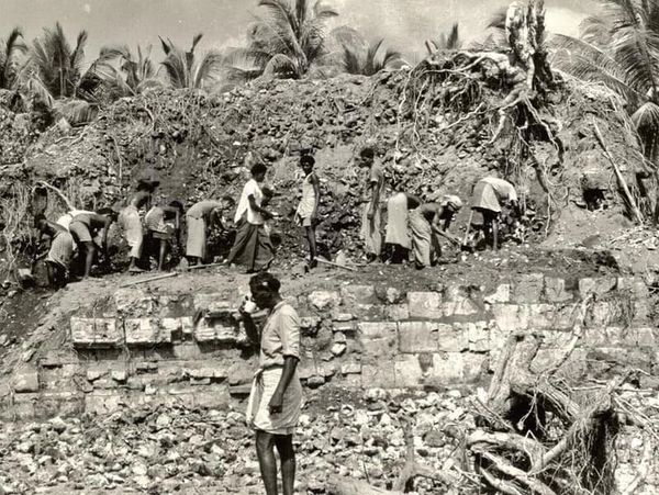 Group of people digging and working at an archaeological or excavation site.
