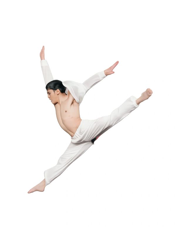 Man performing a high jump split in white pants.
