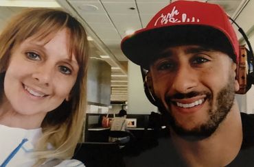 Two people smiling for a selfie in an indoor setting.