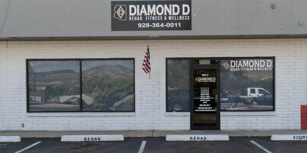 Facade of Diamond D Rehab Fitness & Wellness with parking spaces labeled for rehab.