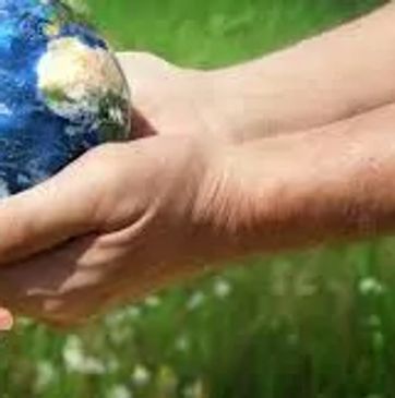 Adult hands passing a globe to child hands symbolizing care for Earth.