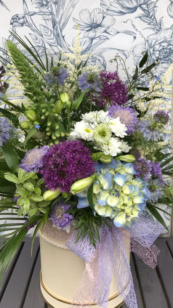 Large hatbox flowers in limes, lilacs and soft hues.