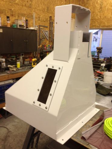 White metal industrial machine casing in workshop.