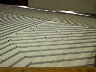 Diagonal striped wall with small black dots.
