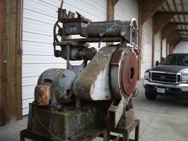 Old industrial machine with rust in a warehouse.