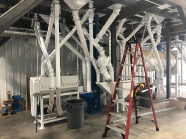 Industrial setup with pipes and a red ladder.