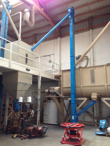 Industrial blue vertical pipeline in a warehouse.