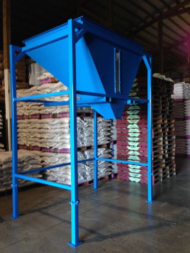 Blue industrial hopper in warehouse.