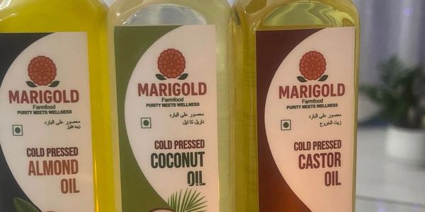 Three bottles of Marigold cold pressed oils: almond, coconut, and castor.