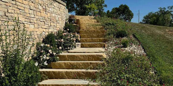 Stone steps surrounded by greenery and flowers.