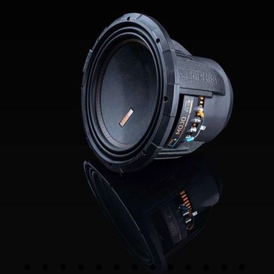 High-performance subwoofer speaker with sleek black design on reflective surface.
