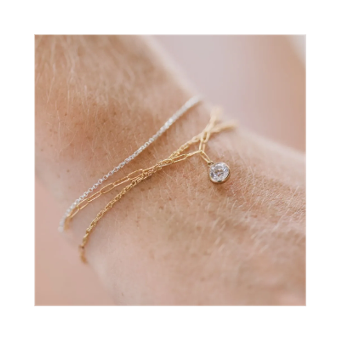 Gold and silver permanent bracelets with crystal charm.