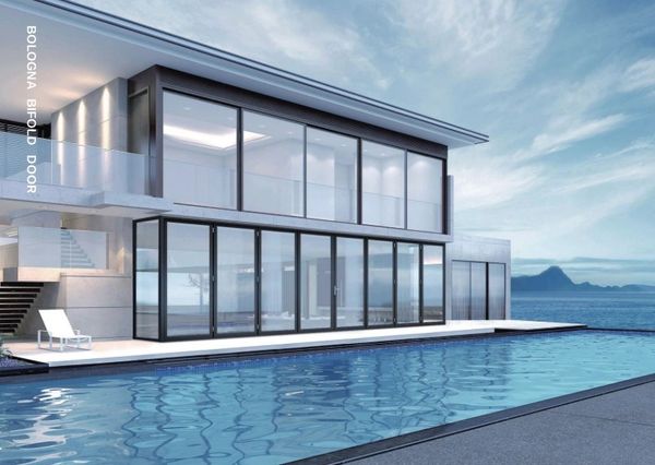 Modern house with large glass bifold doors and a pool.