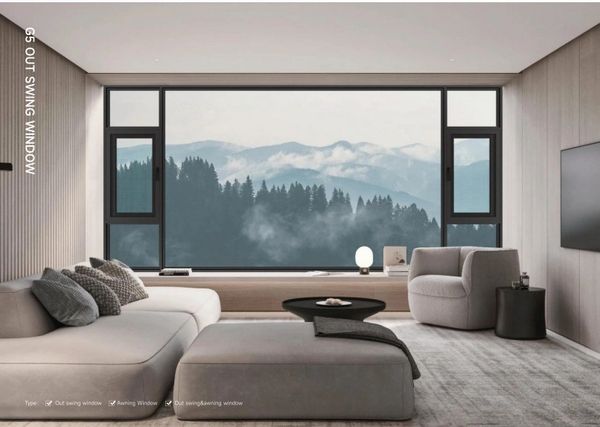 Modern living room with large windows showcasing misty mountain views.