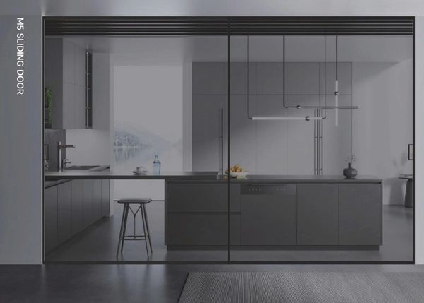 Modern kitchen with sleek grey sliding glass doors and minimalist design.