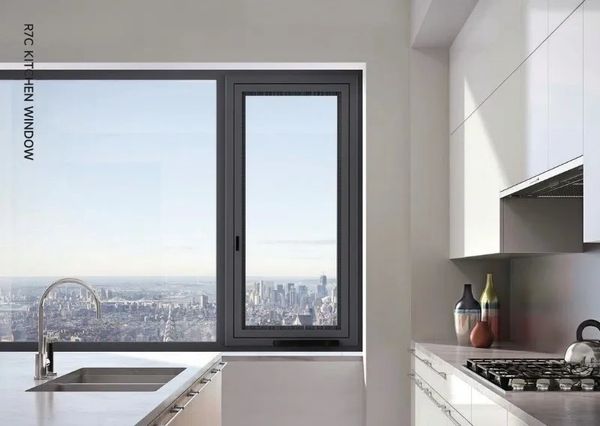 Modern kitchen with a large window offering city skyline views.