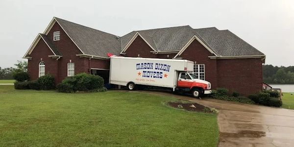 Moving truck crashed into a brick house's corner.