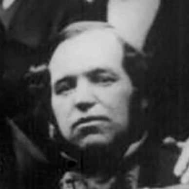 Black and white close-up portrait of a man with a serious expression.