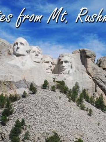 Mount Rushmore National Memorial under blue sky.