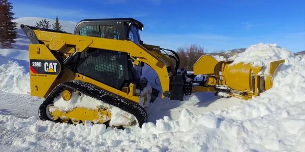 Our skid steer taking on a huge pile of snow for one of our customers.