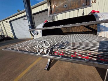 Custom metal grill with Texas star emblem in front of industrial buildings.