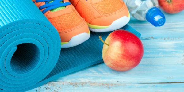 Yoga mat, running shoes, and apple.