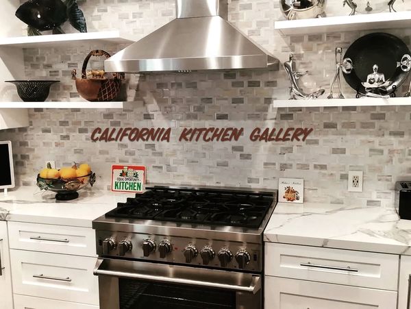 white kitchen cabinets with marble look counter top and marble backsplash and floating shelve