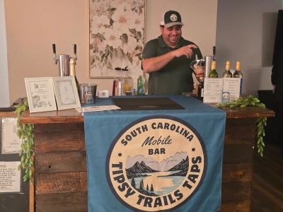 Man pouring a drink at a South Carolina mobile bar.