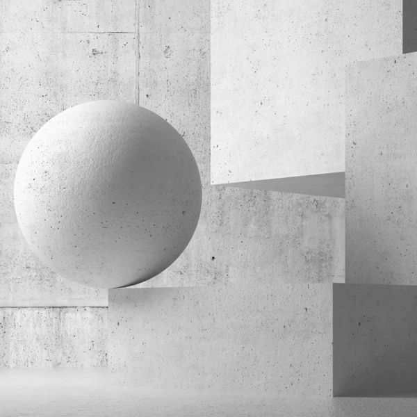 Large textured concrete sphere balanced on geometric concrete blocks.
