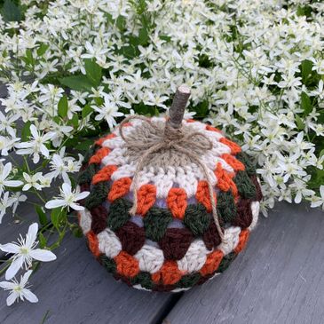 Granny stitch pumpkin with a twig stem and twine bow.