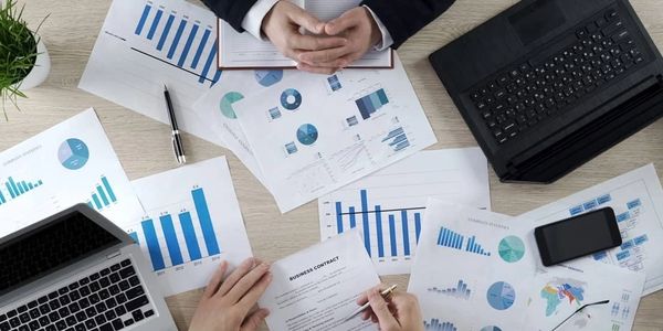 Business meeting with charts and contract.
