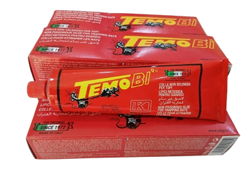 Red tube and boxes of Tempo BI glue with cat logo and Italian text.