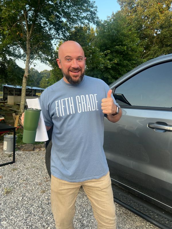 Brett Difani wearing 5th grade teacher t-shirt.