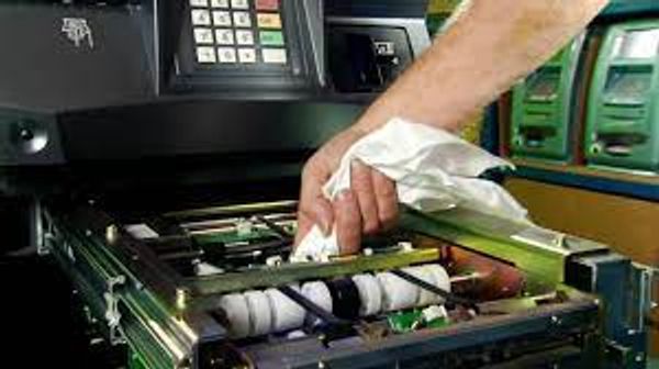 Hand repairing the internal components of an ATM machine.