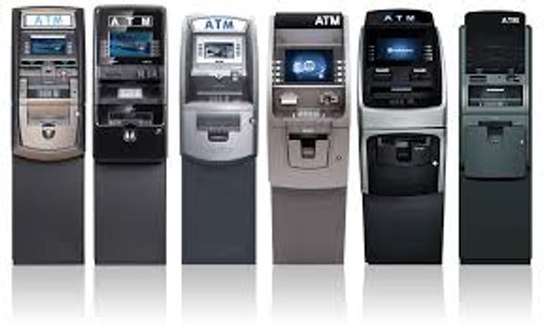 A lineup of six different ATM machines in various designs and colors.