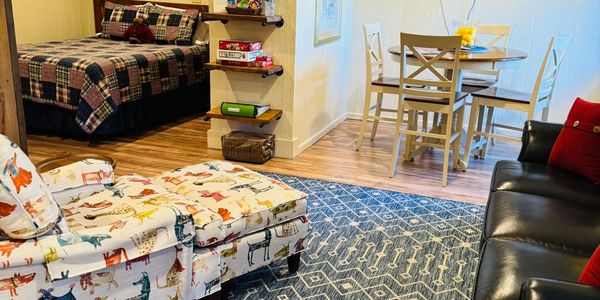 Cozy living area with animal-patterned chair and dining table.