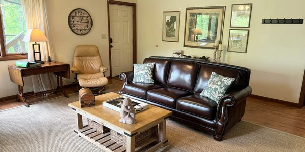 Den area of Lone Star Retreat #3 in Lake Junaluska, NC, featuring a leather sleeper sofa.