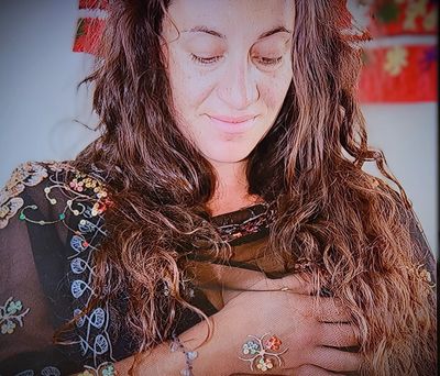Photo of Natasha Bebonis, creative behind Sacred Emanations with hands on heart in about section