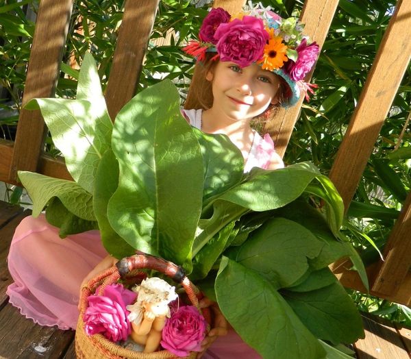 Selene with comfrey harvest & crown of freshly picked spring flowers from our Eden Apothecary garden