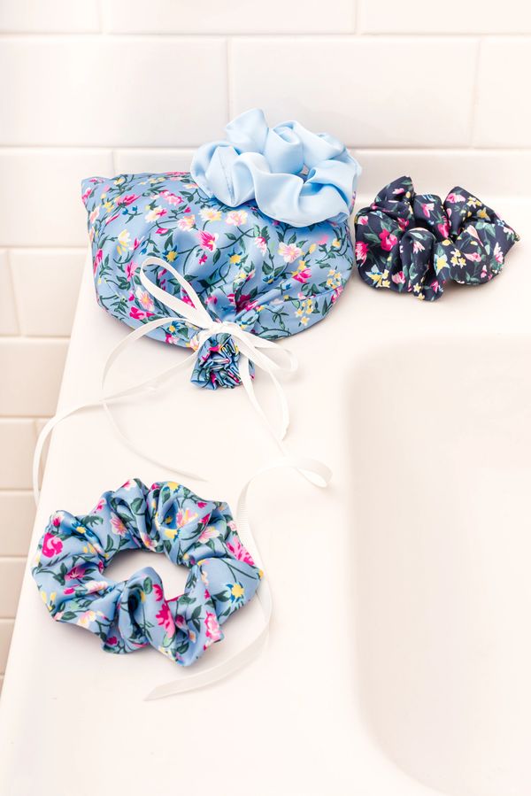 Floral blue scrunchies with matching blue floral bag sitting on white sink