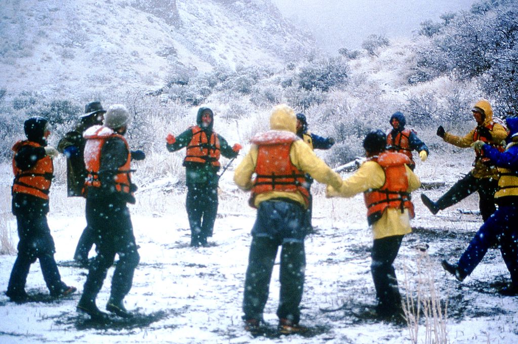 Doing calisthenics to warm up during a winter-rafting expedition on Oregon's remote Owyhee River.