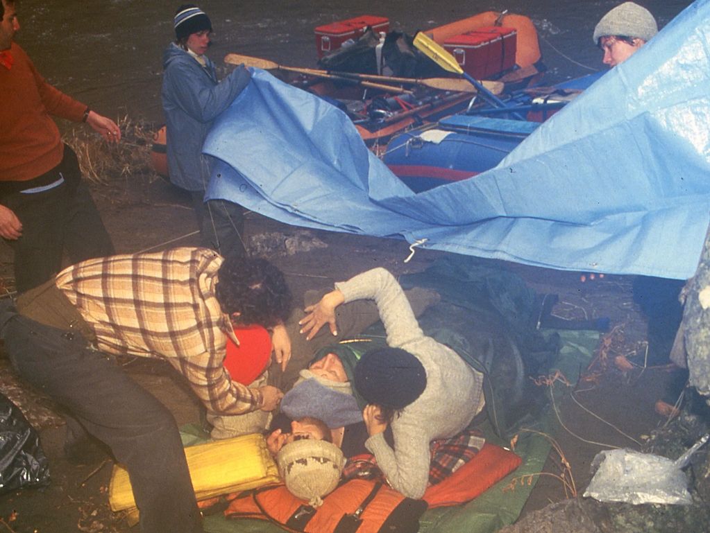 My buddies treat me for severe hypothermia after swimming Montgomery Rapid on the Owyhee River.