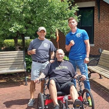 Three warriors posing for a picture with cycle 