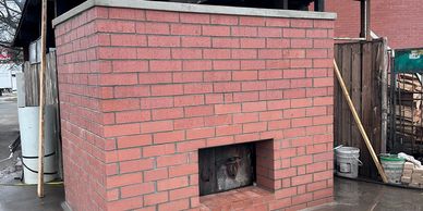 Brick outdoor fireplace or oven structure.