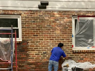Brick tuckpointing restoration in atlanta ga, Applying new groute to brick wall 