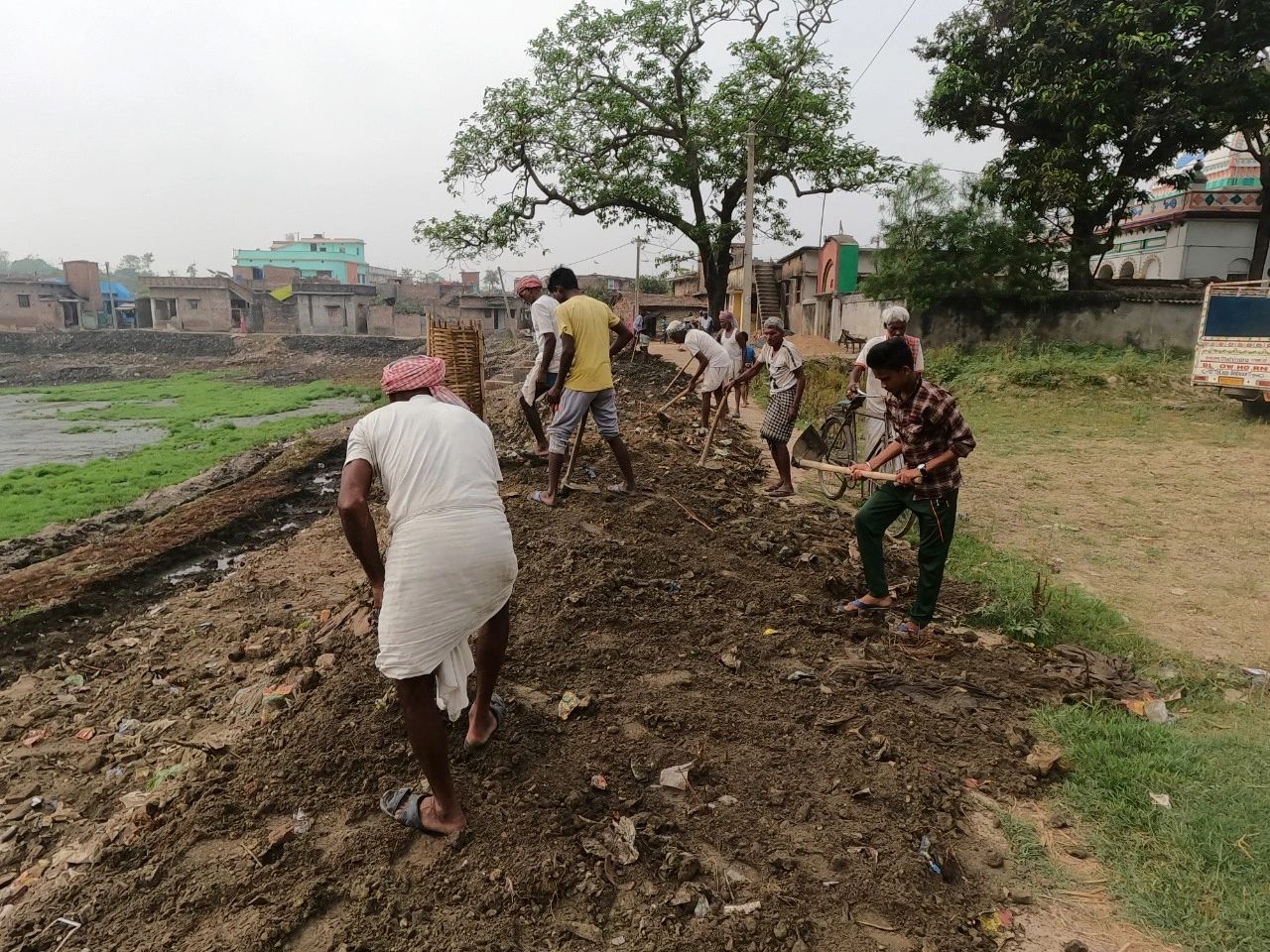 Community members clearing the banks of a pond in Darbhanga.