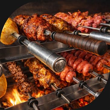 Various meats grilling on skewers over an open flame.