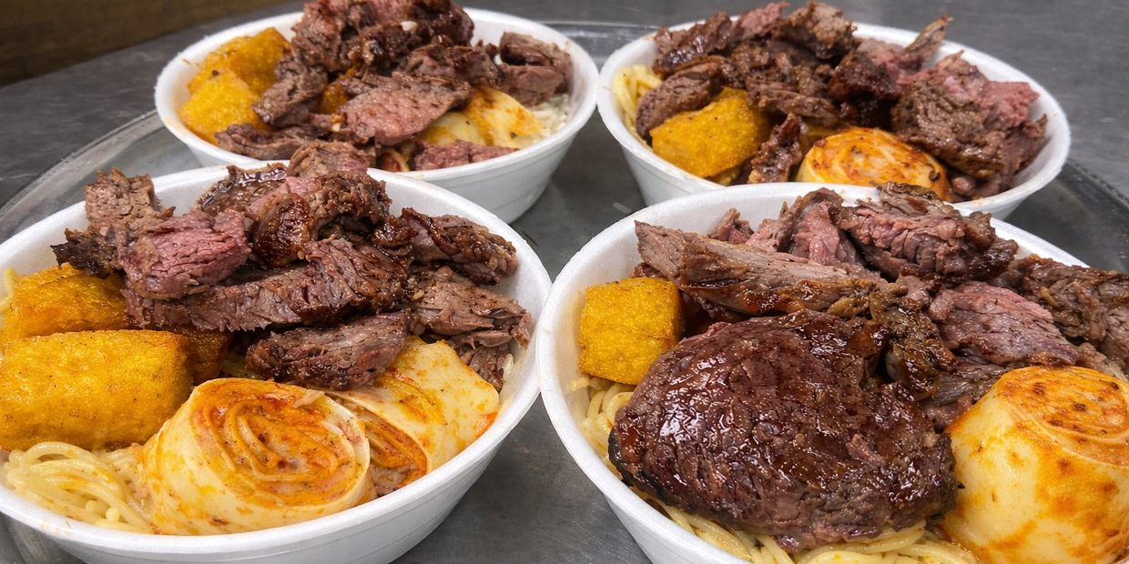 Four bowls of grilled steak, fried rolls, and golden fried sides over noodles.