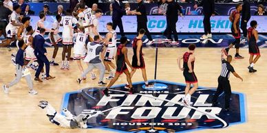 Players walking off the basketball court after an NCAA Final Four game in Houston.