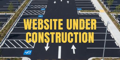 Empty parking lot with 'Website Under Construction' text.